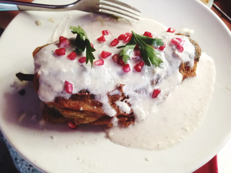 High Angle View Of Chiles En Nogada Served In Plate On Table